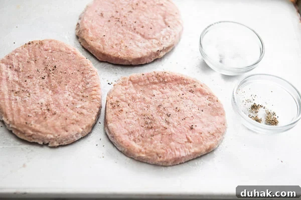 Air Fryer Guide: Perfectly Crispy Frozen Turkey Patties in Minutes 9 Season frozen turkey Pattie on a cutting board