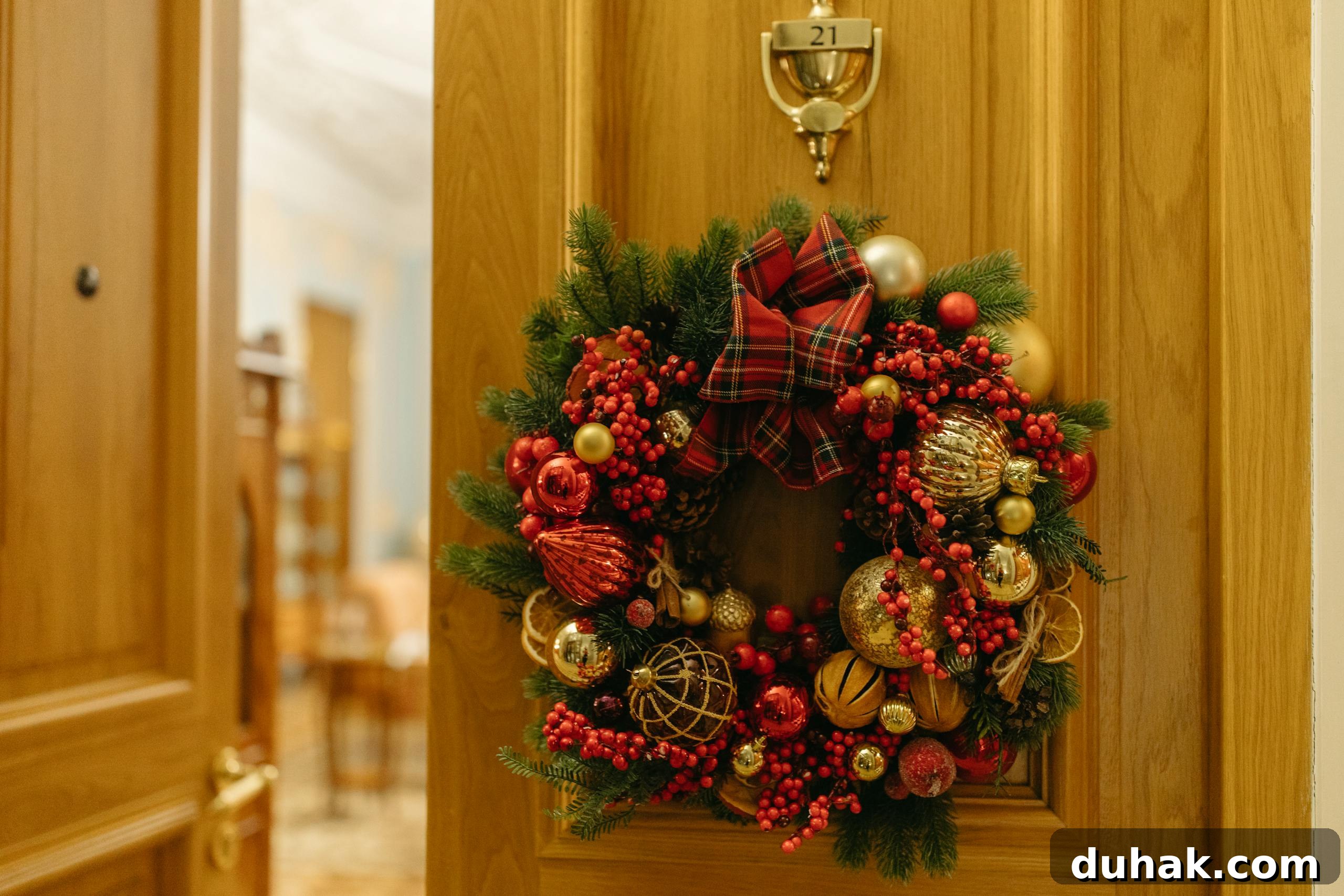 Decorative Christmas wreath with baubles and berries adorning a wooden door.