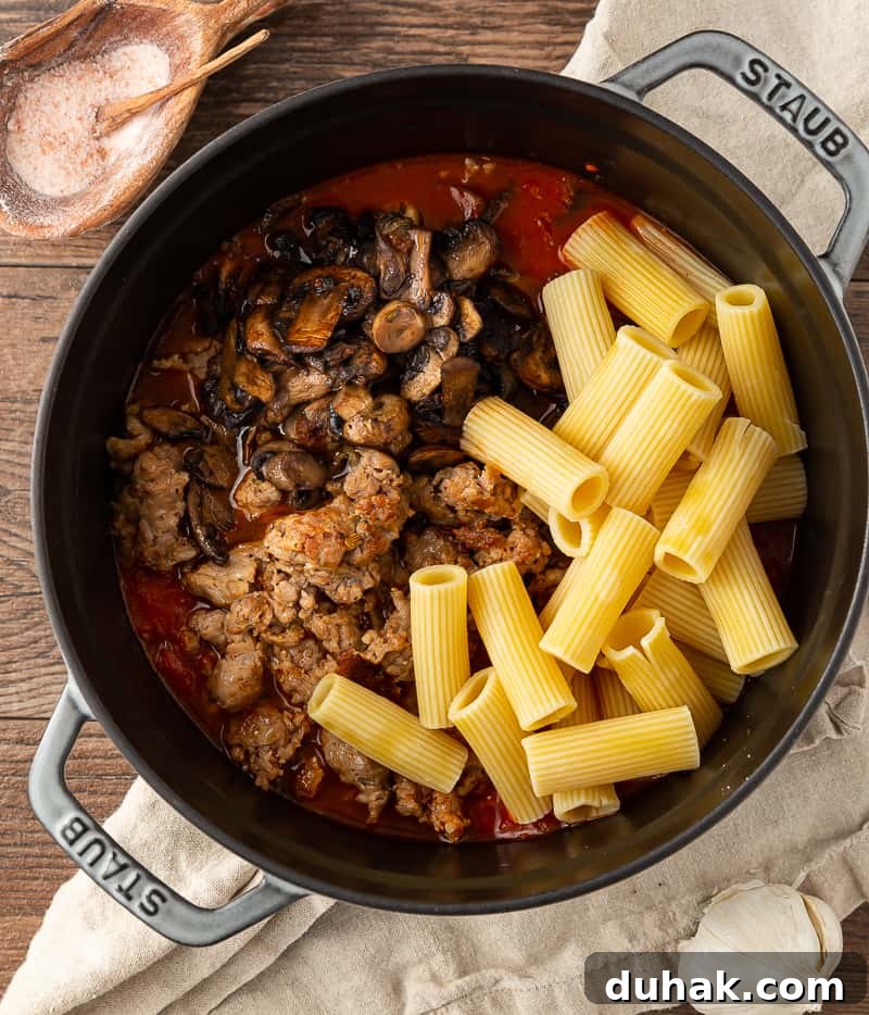 Creamy Baked Rigatoni with Italian Sausage and Mozzarella 3 ingredients ready to be stirred for pasta al forno