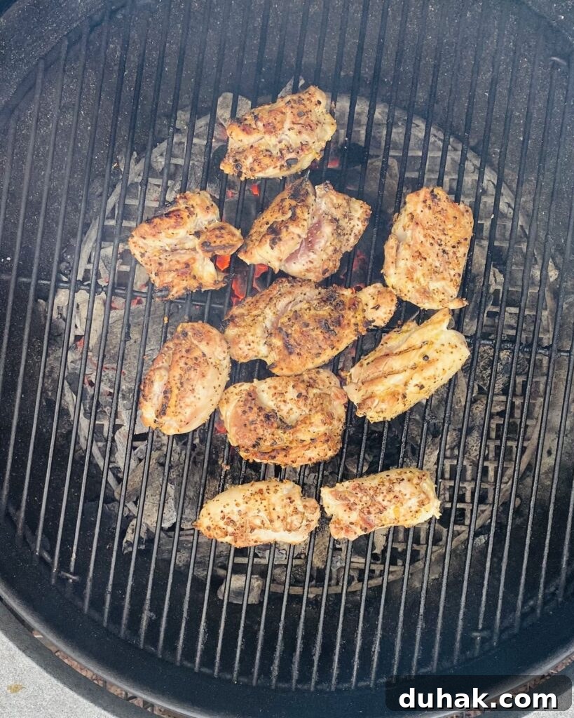 Grilled Chicken with Tomato Bruschetta and Goat Cheese 4 chicken thighs grilling on a Weber grill