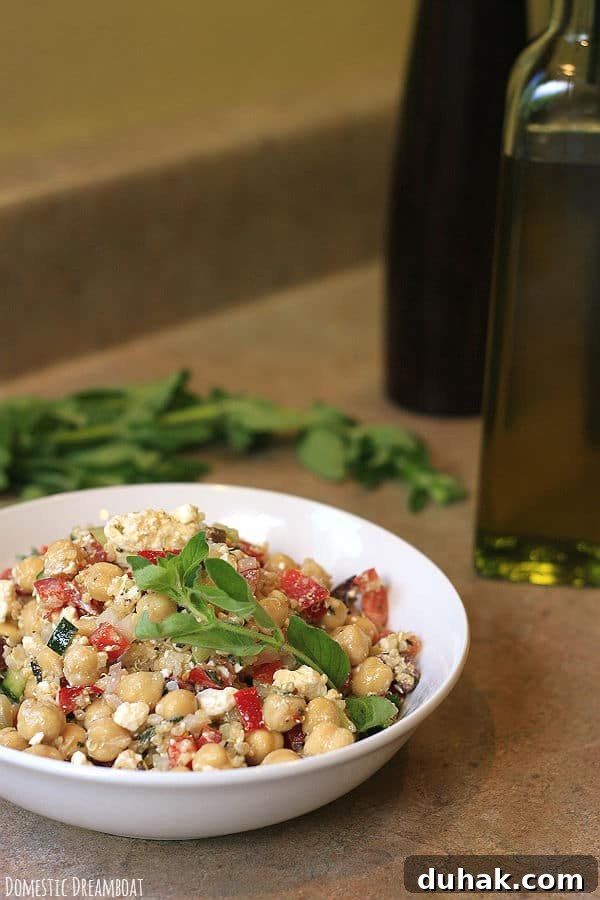Greek Chickpea & Quinoa Salad with Feta and Lemon Dressing 4 Chickpea and quinoa salad in a white bowl.