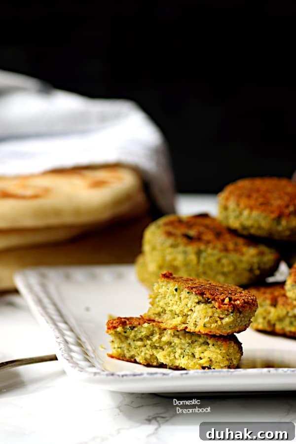 Greek Chickpea & Quinoa Salad with Feta and Lemon Dressing 5 Two halves of a falafel stacked on top of another.