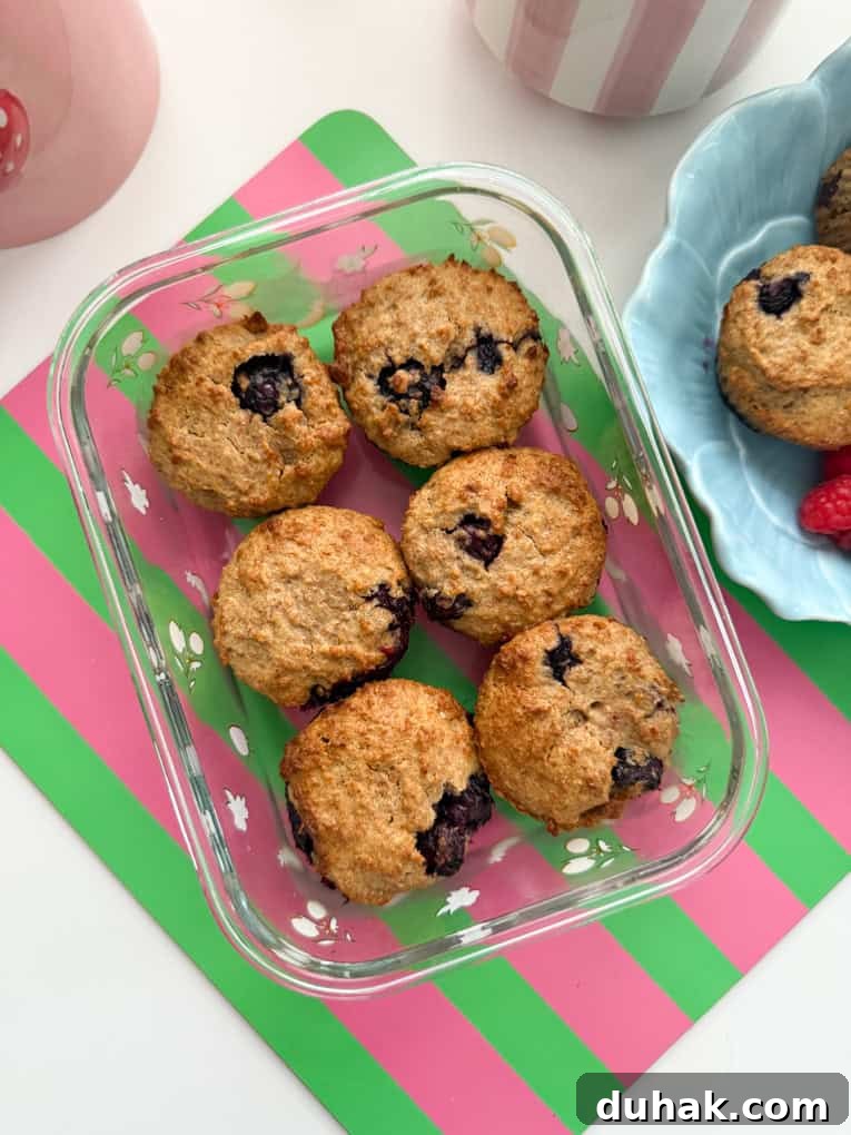 Six muffins served in a glass dish.