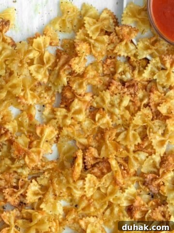 baked pasta chips with marinara sauce.