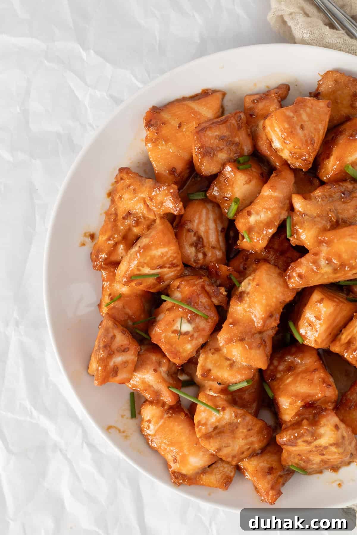 salmon bites on a white plate.