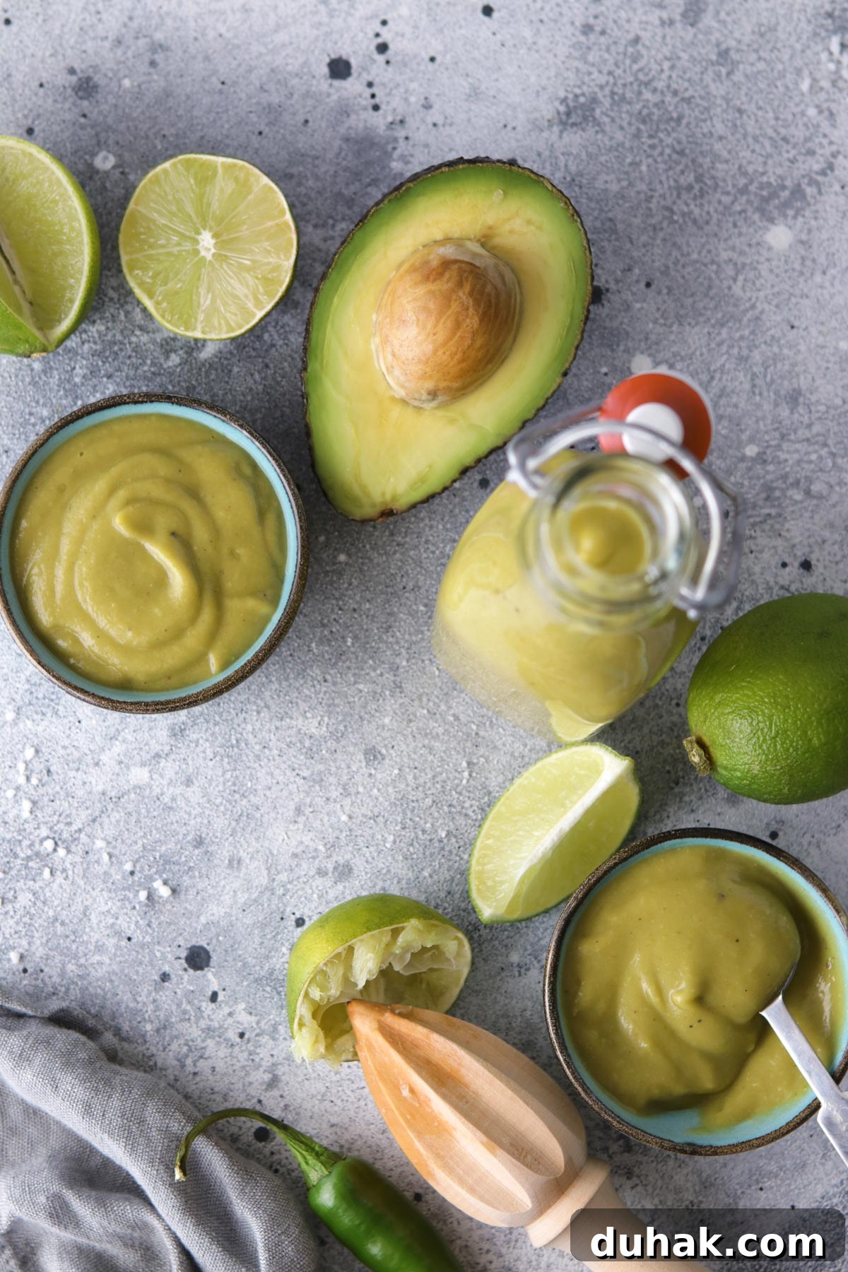 Creamy Avocado Vegan Dressing Recipe for Salads & Bowls 8 Avocado Sauce in Small Bowls Surrounded by Ingredient Props