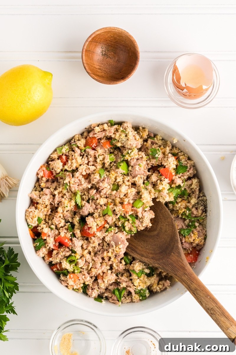 Canned tuna patties ingredients mixed together in a mixing bowl. Hostess At Heart