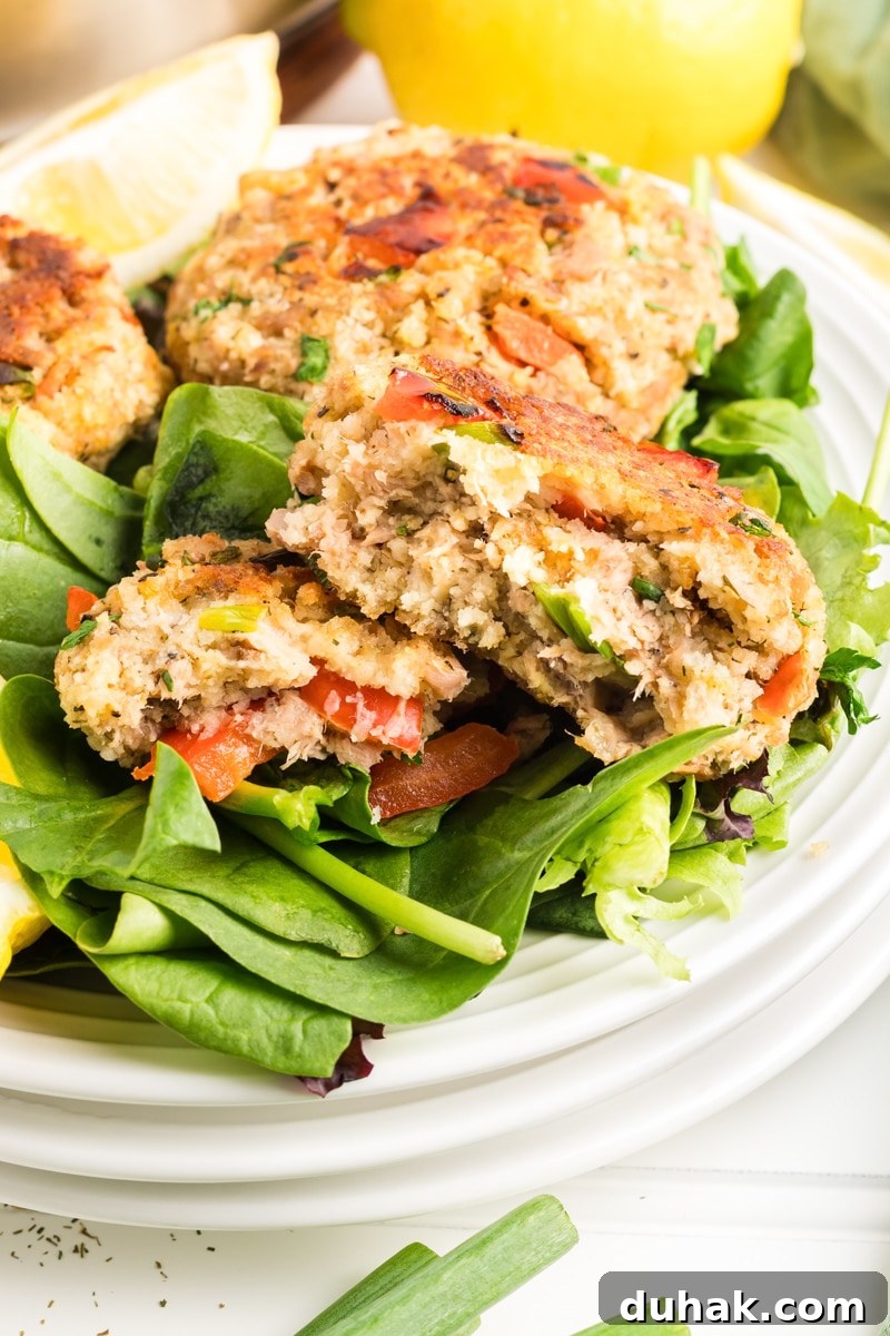 Tuna patties burger fried golden brown sitting on a bed of lettuce - Hostess At Heart