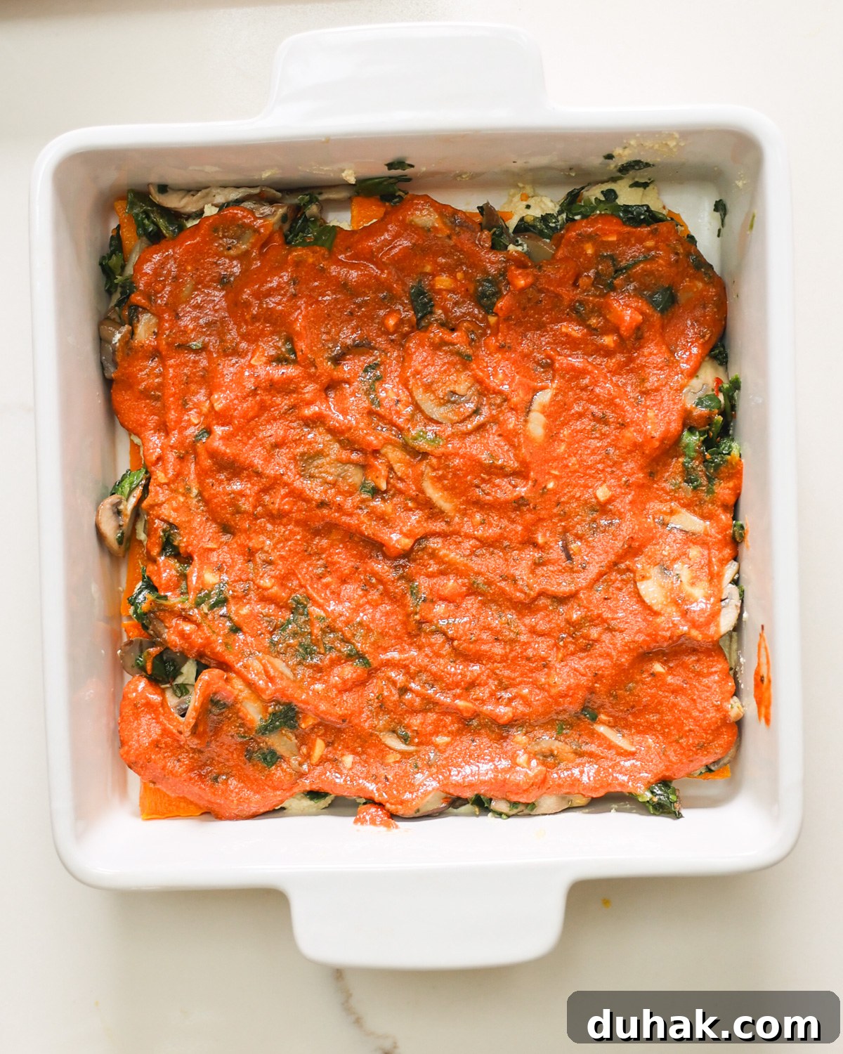 tomato sauce layered on butternut squash lasagna