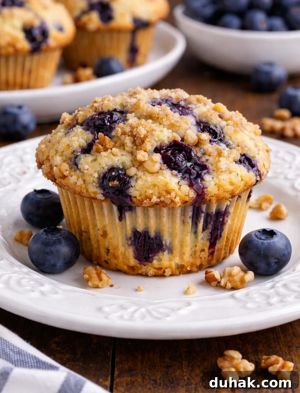 Fluffy Blueberry Muffins with Crunchy Walnuts 2 Blueberry Walnut Muffin on a pretty white plate