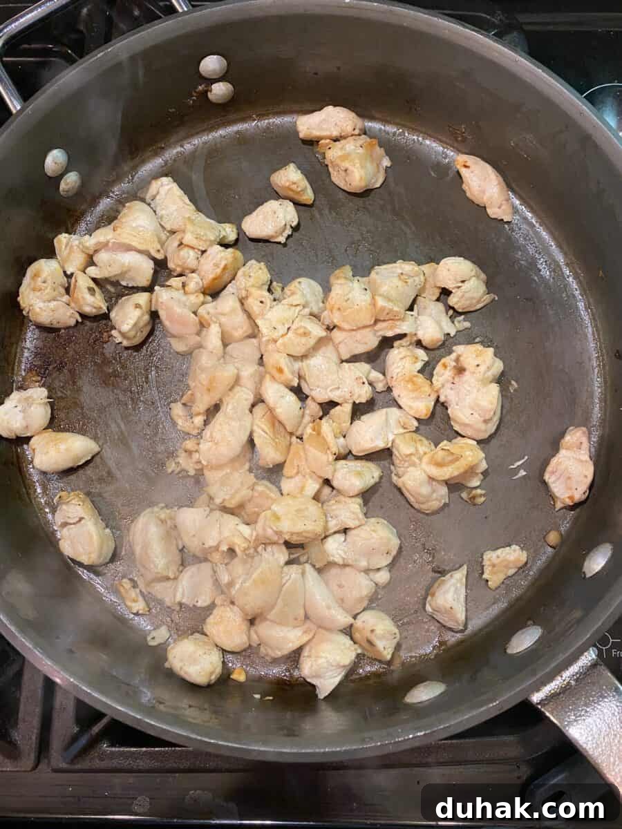 Creamy Spicy Alfredo Sauce Recipe for Pasta and Wings 7 Diced chicken, cooked and in a skillet on the stove.