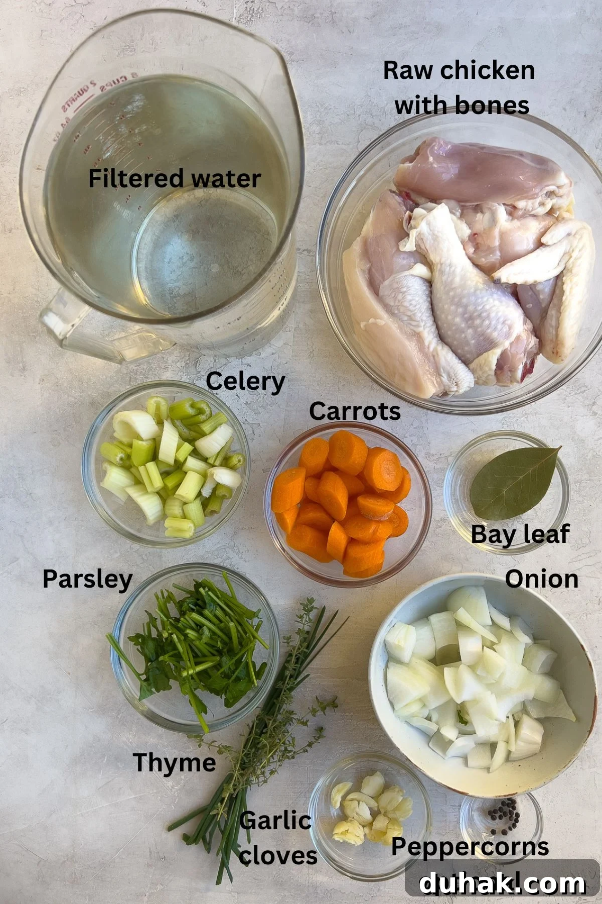 Ingredients for chicken broth on the counter in prep bowls. 