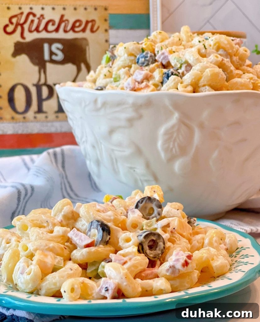 Creamy Summer Macaroni Salad in a large serving bowl and on a salad plate.