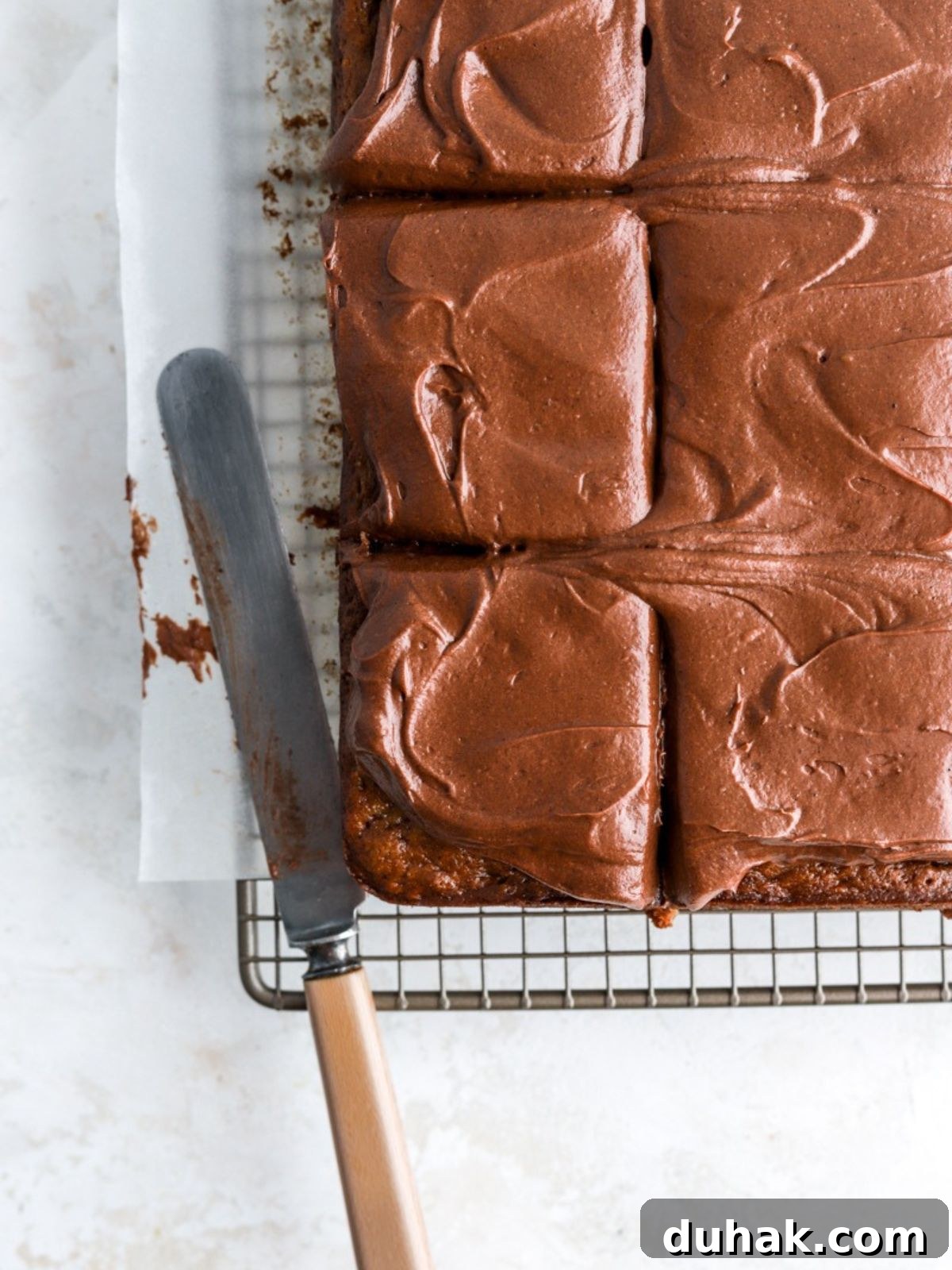 Moist Banana Spice Cake Recipe with Warm Cinnamon Flavor 11 Sliced banana cake with chocolate frosting