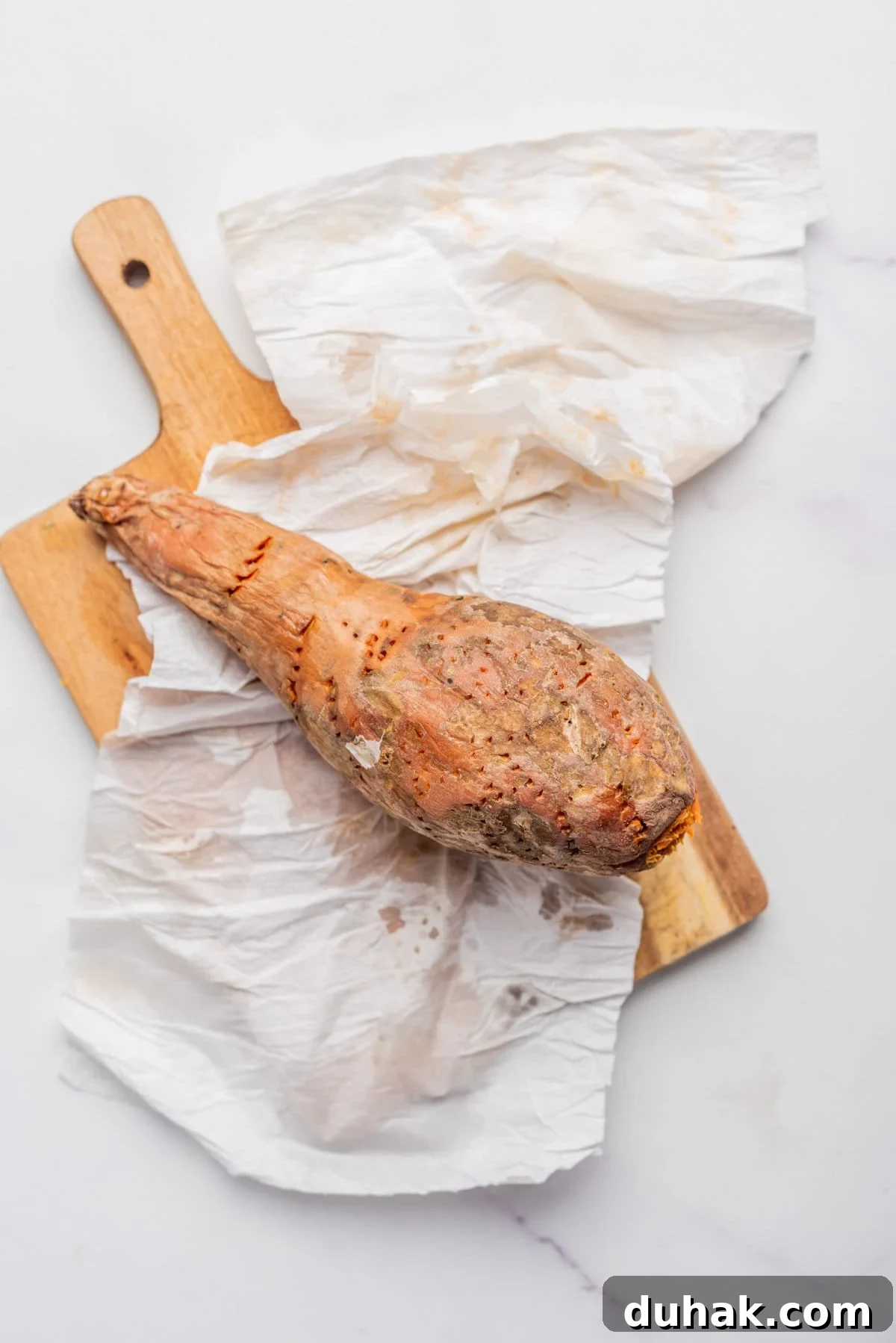 How to Cook a Sweet Potato in the Microwave Fast 6 An image of microwave sweet potato unwrapped from a damp paper towel and resting on a chopping board.