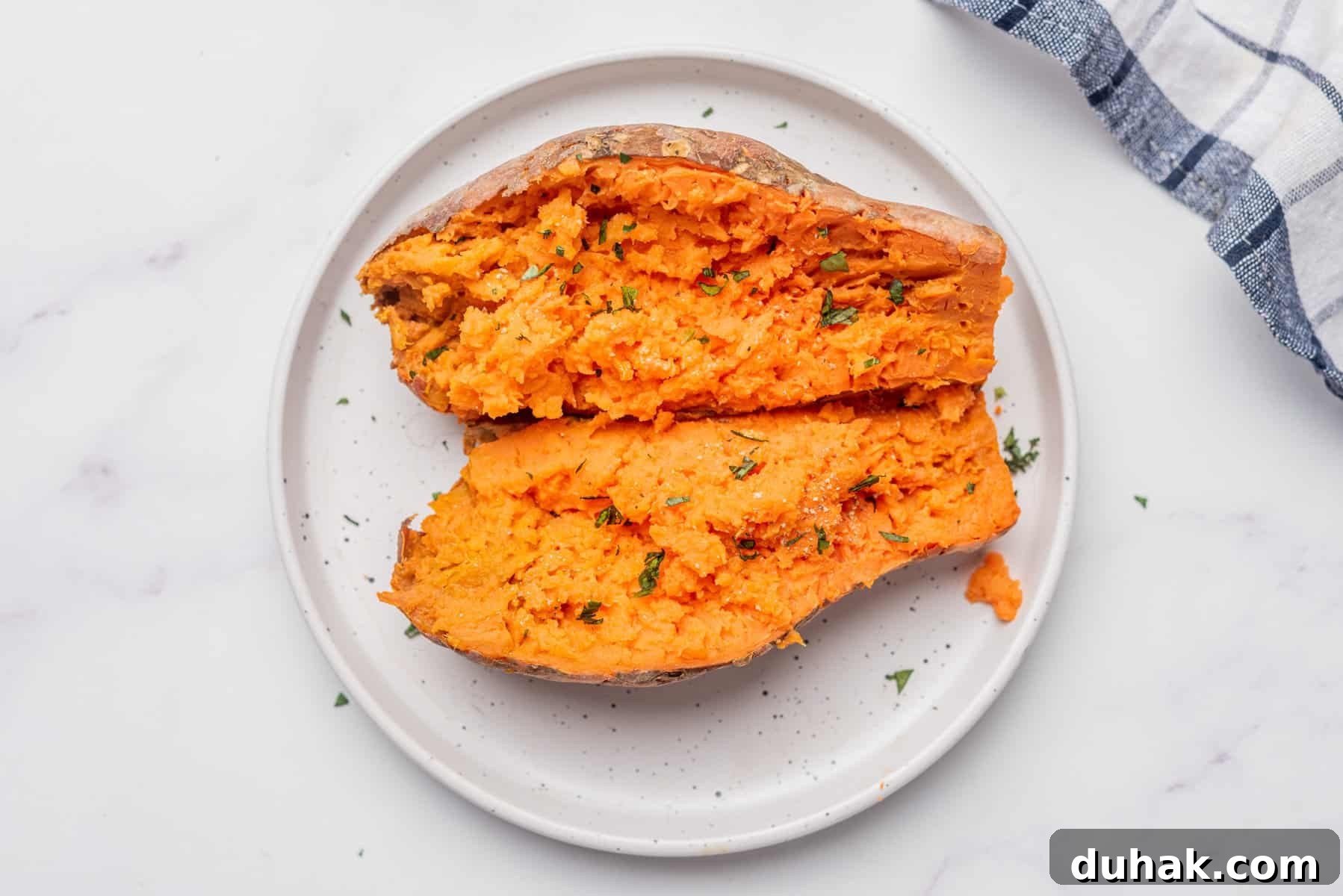 How to Cook a Sweet Potato in the Microwave Fast 9 An overhead image of microwaved sweet potatoes on a plate.