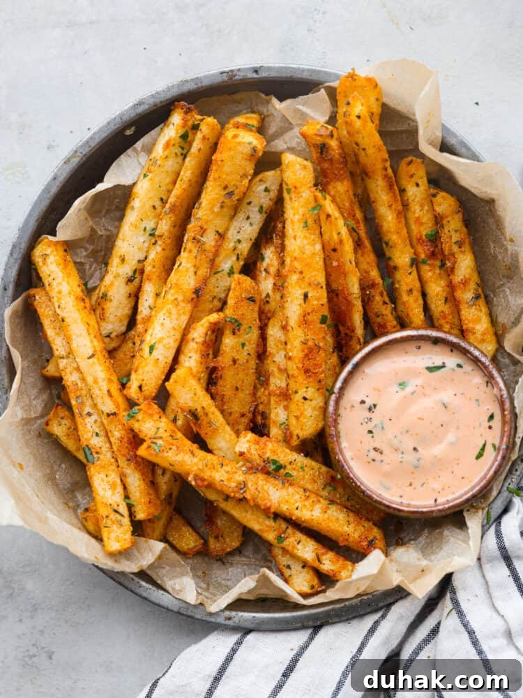 Top-down view of jicama fries served with fry sauce.