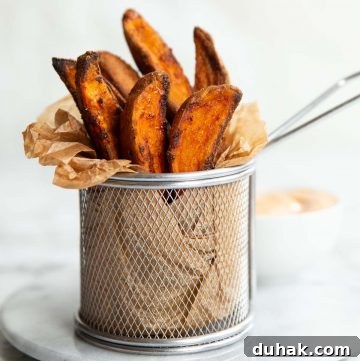 wedges in a small fry container on marble board with dip blurred in background