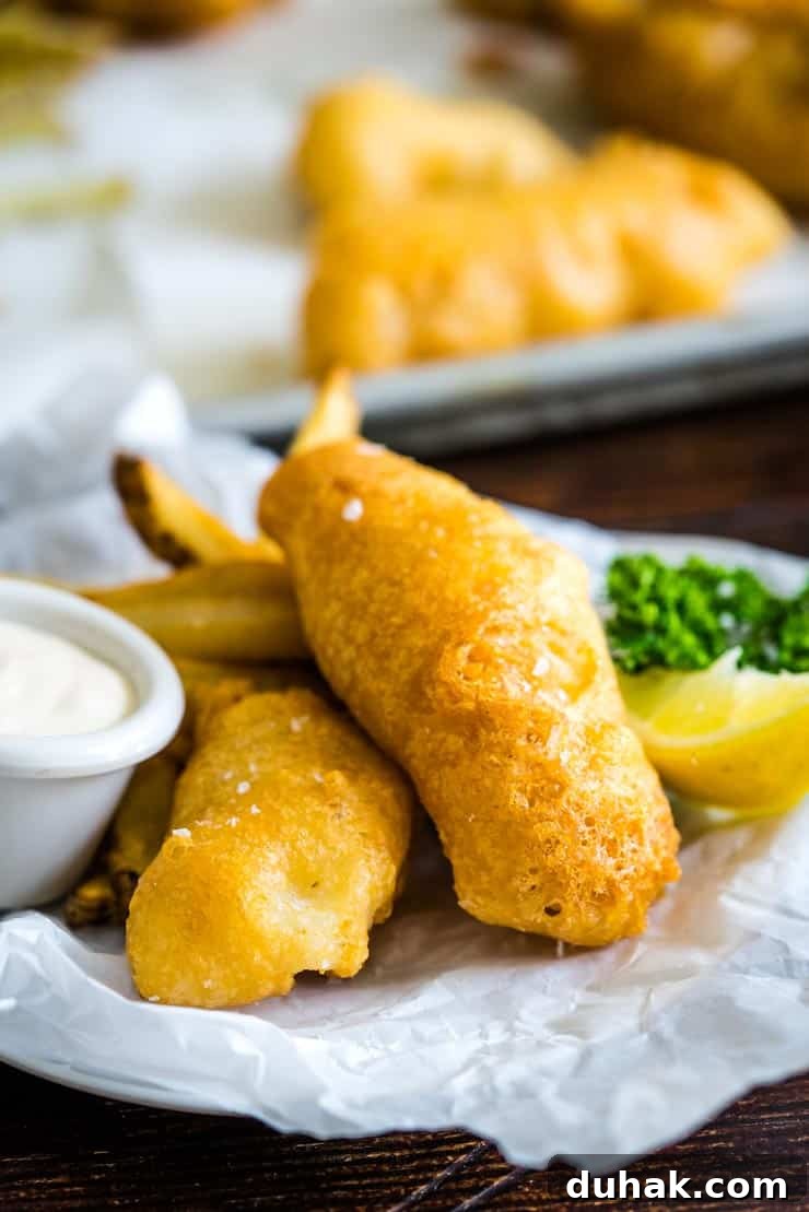 Beer Battered White Fish on a plate with homemade french fries and tartar sauce
