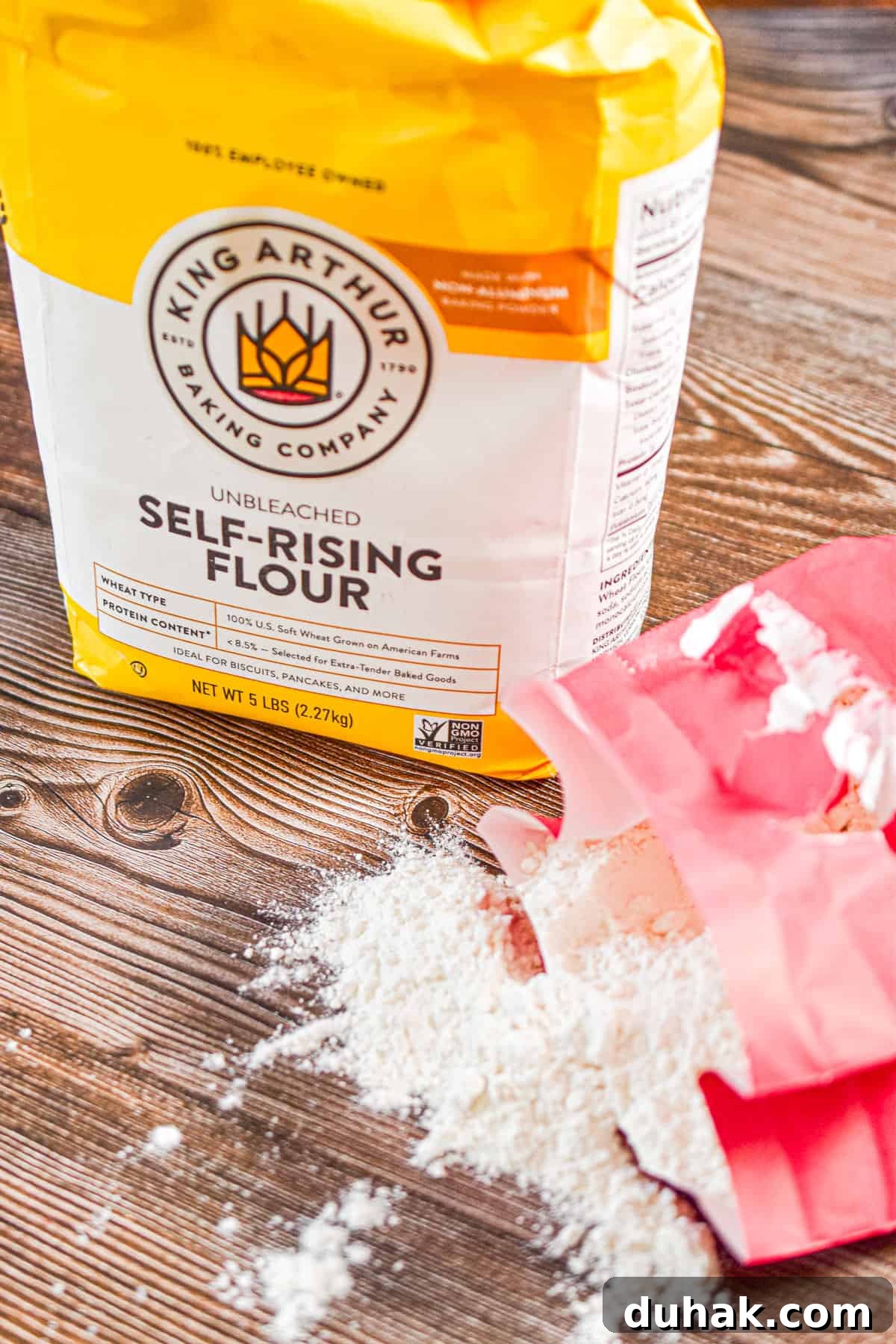 All-Purpose vs Self-Rising Flour: When to Use Each Type 5 A bag of self rising flour is standing next to a bag of all purpose flour spilt below it.