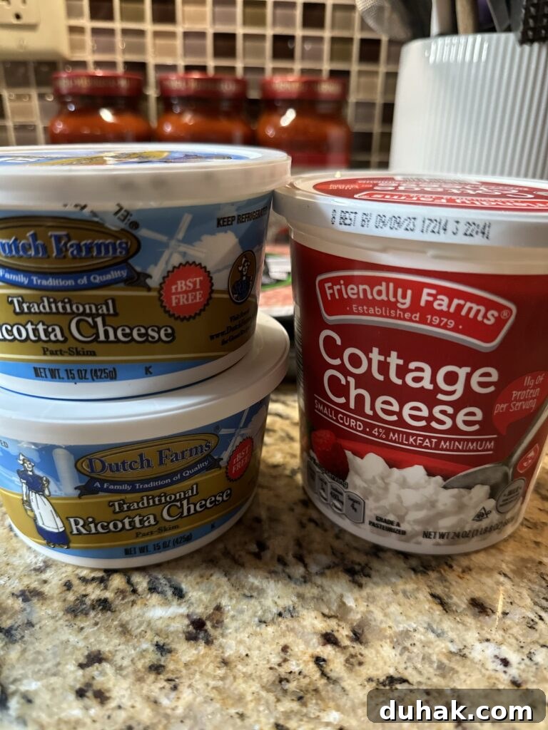 Authentic Italian Lasagna Recipe for Rich, Homemade Flavor 3 Two containers of ricotta cheese stacked on top of each other and a container of cottage cheese next to them