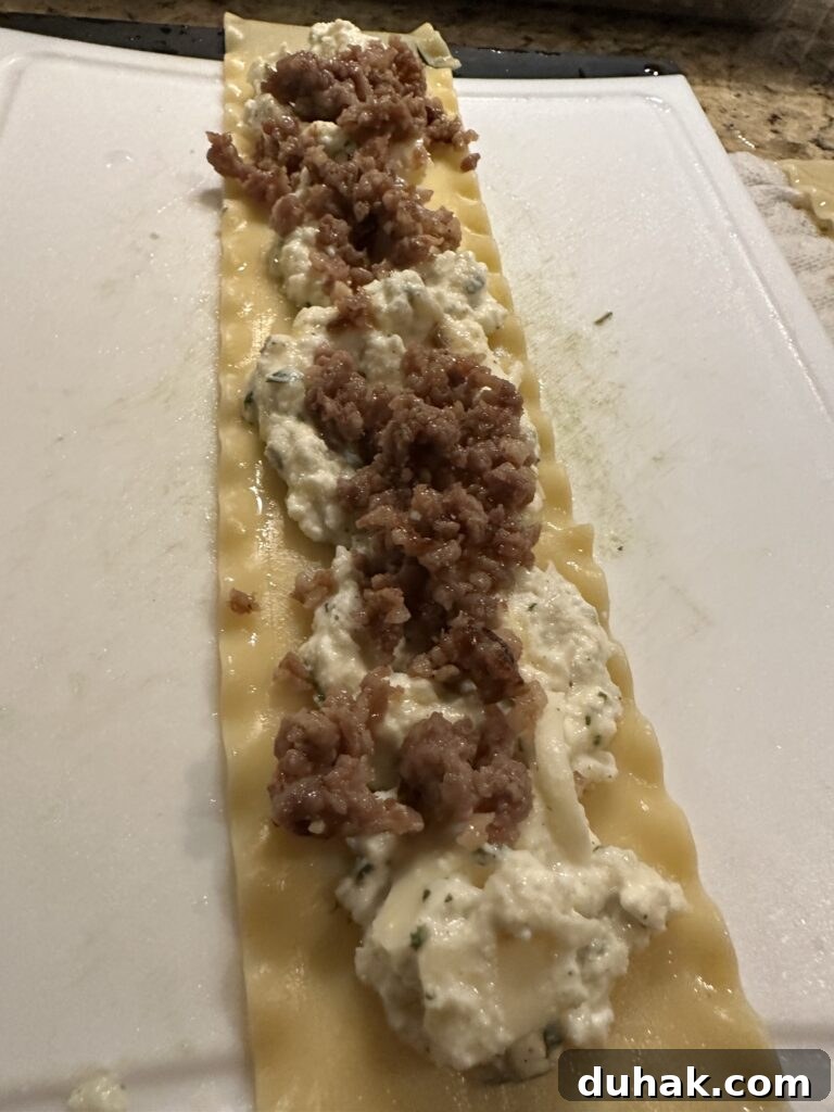 Authentic Italian Lasagna Recipe for Rich, Homemade Flavor 6 Crumbled sausage on top of the cheese mixture on a lasagna noodle