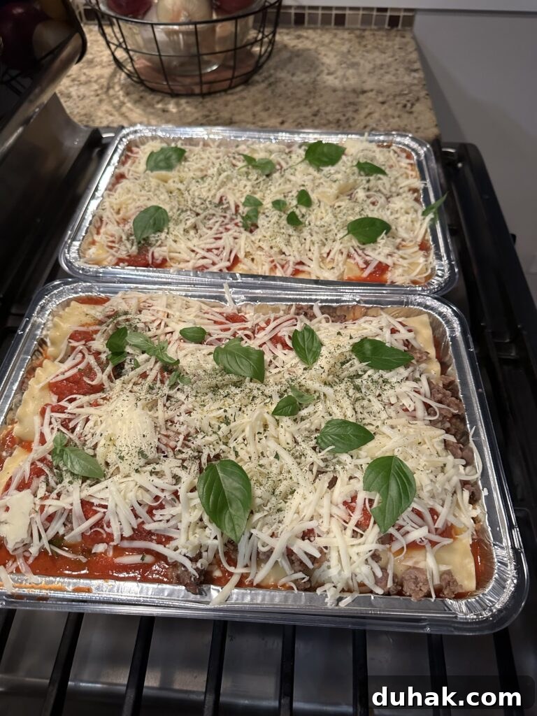 Authentic Italian Lasagna Recipe for Rich, Homemade Flavor 10 The two lasagnas topped with shredded cheese and basil before being put in the oven