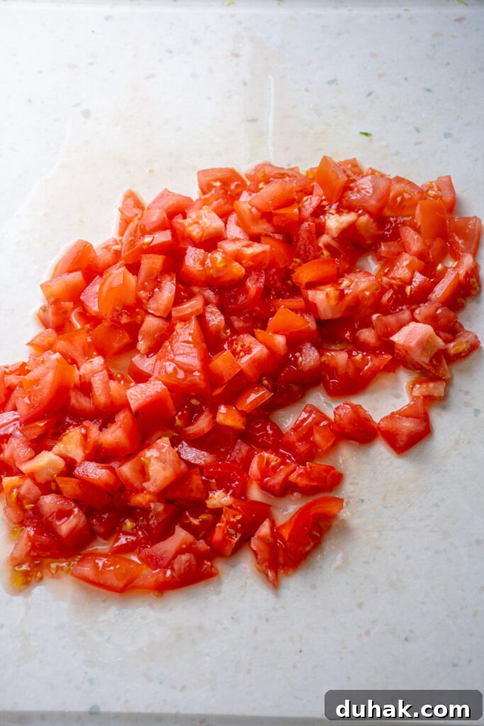 Chopped tomatoes on a cutting board.