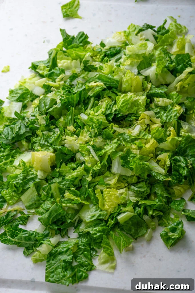 Chopped lettuce on a cutting board.