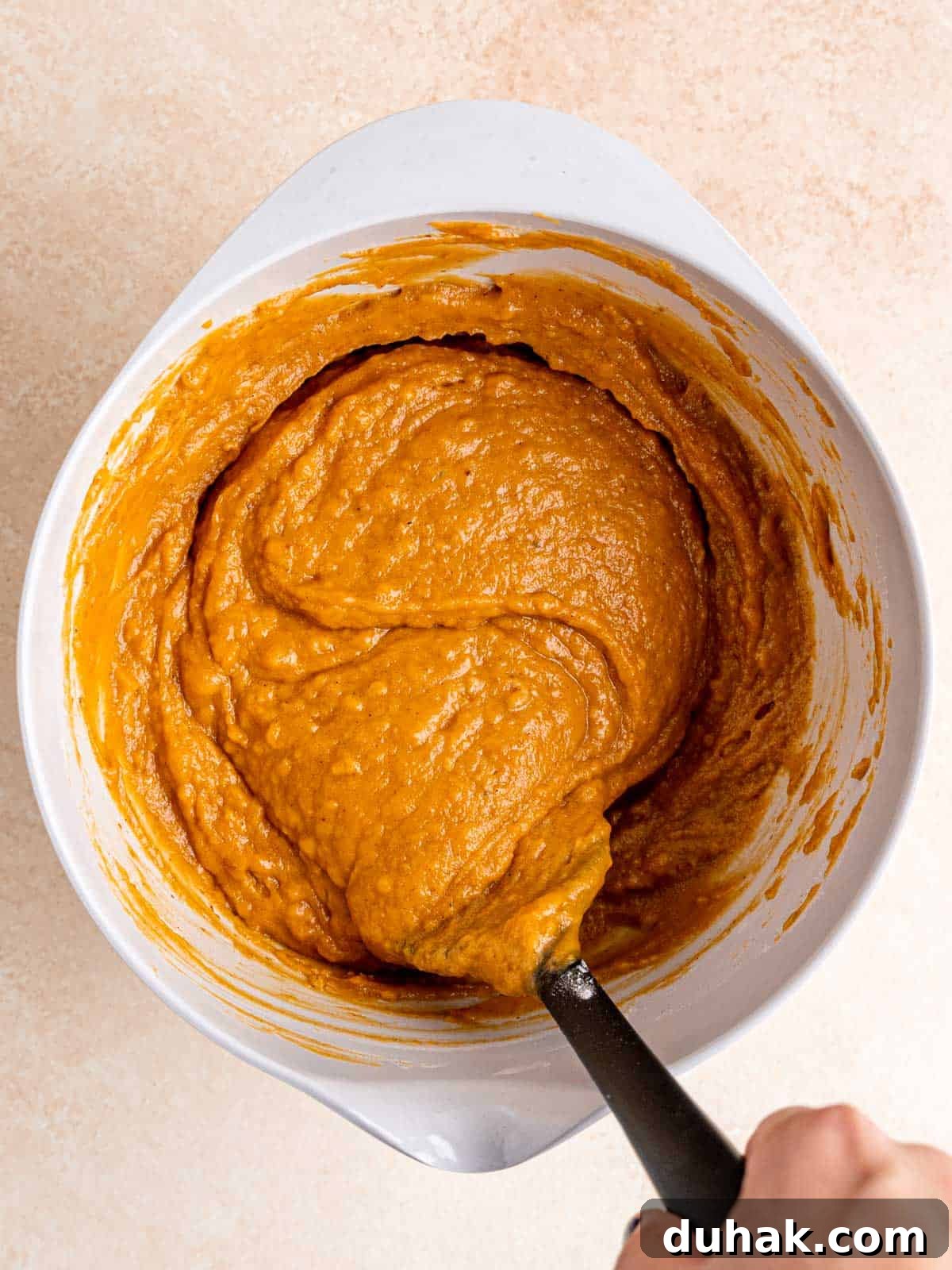 Pumpkin Snickerdoodle Quick Bread Recipe for Fall Baking 6 Folding dry ingredients into wet ingredients using a spatula.