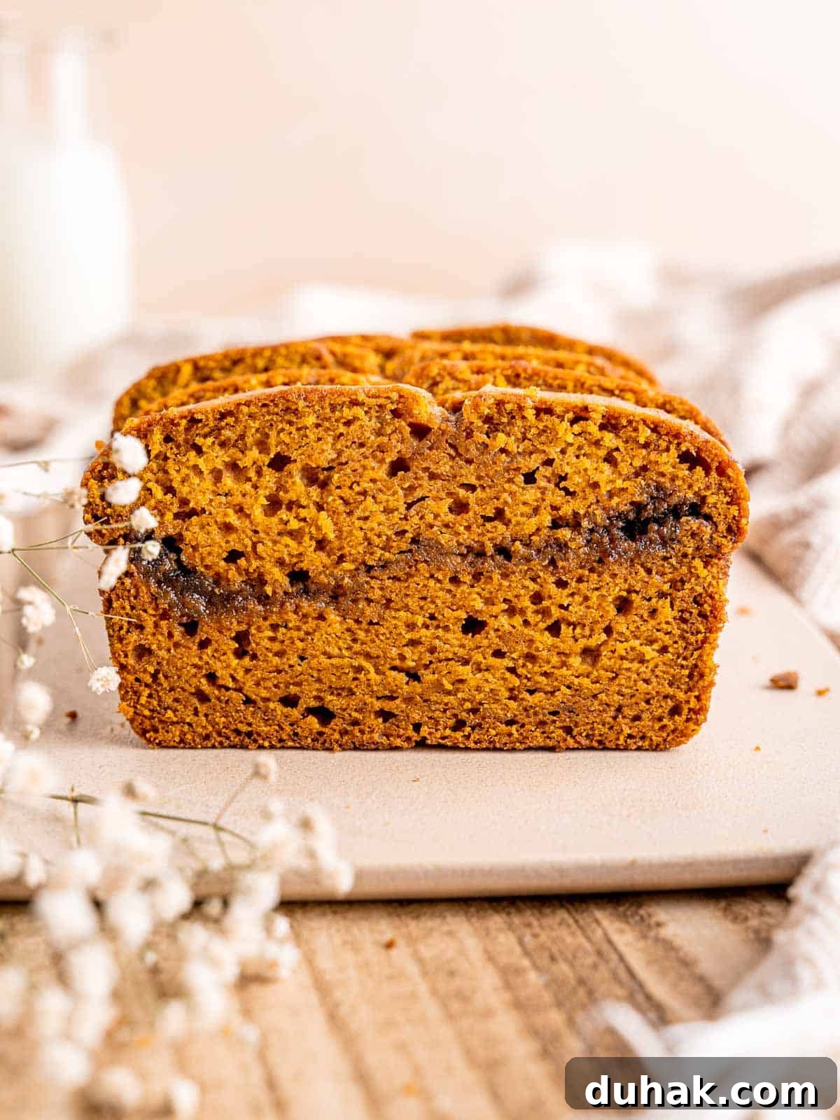 Pumpkin Snickerdoodle Quick Bread Recipe for Fall Baking 8 Pumpkin bread with a cinnamon sugar swirl in the middle.