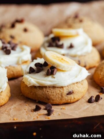 gluten free banana bread cookies with cream cheese frosting. topped with mini chocolate chips and fresh sliced bananas