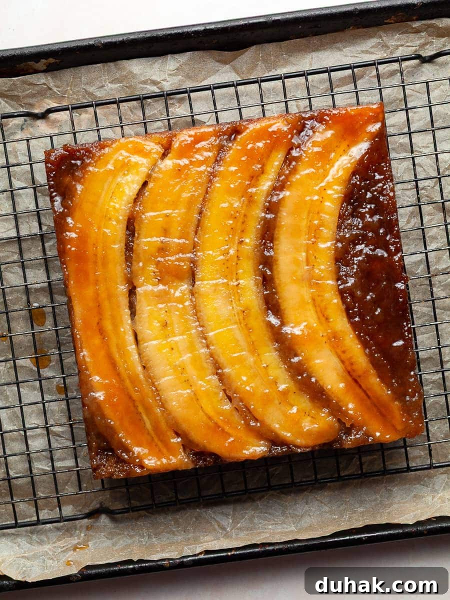 gluten free banana upside down cake. a moist banana cake topped with brown sugar caramelized bananas, on a cooling rack
