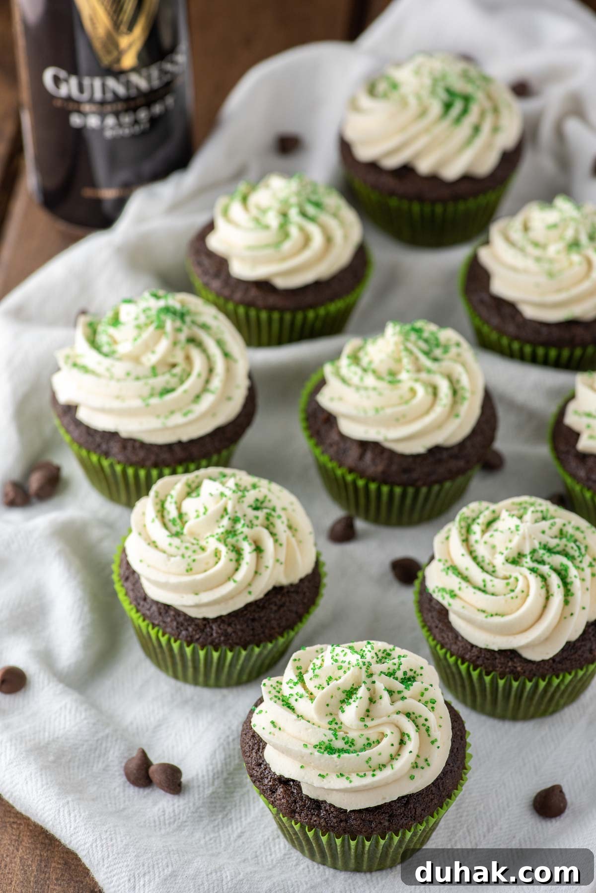 Guinness and Bailey’s Irish Car Bomb Cupcakes Recipe 3 nine Irish Car Bomb cupcakes on white dish towel with Guinness beef in background