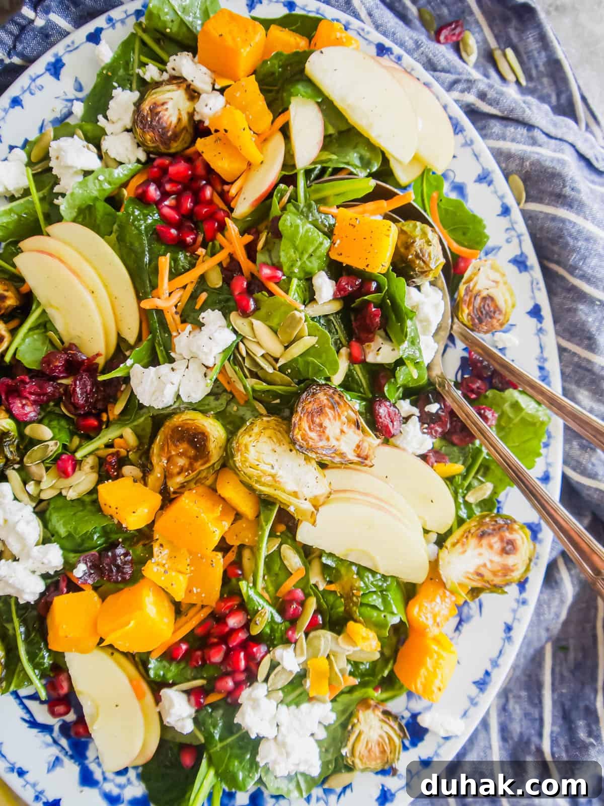 Autumn Harvest Salad with Maple Vinaigrette and Roasted Squash 2 Fall harvest salad recipe in a large serving plate with a large spoon inside.