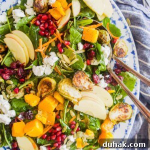 Autumn Harvest Salad with Maple Vinaigrette and Roasted Squash 11 Fall harvest salad recipe in a large serving plate with a large spoon inside.