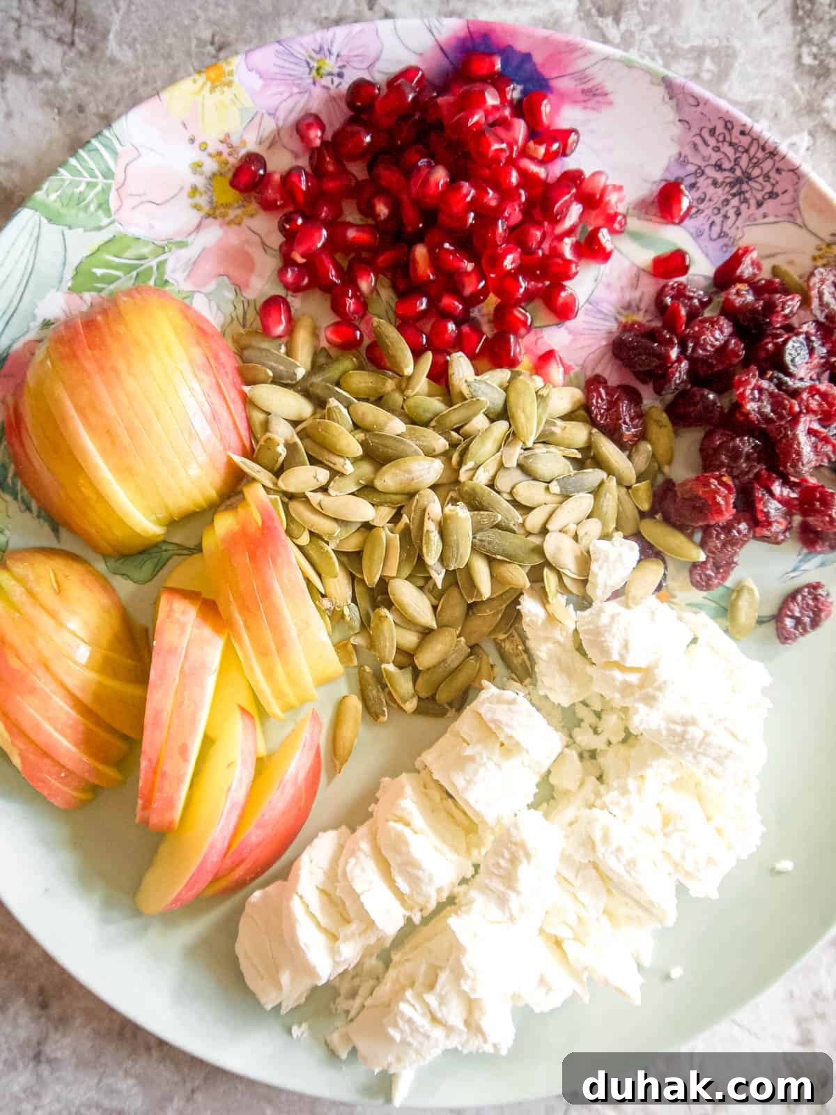 Autumn Harvest Salad with Maple Vinaigrette and Roasted Squash 7 Salad ingredients prepped on a plate.