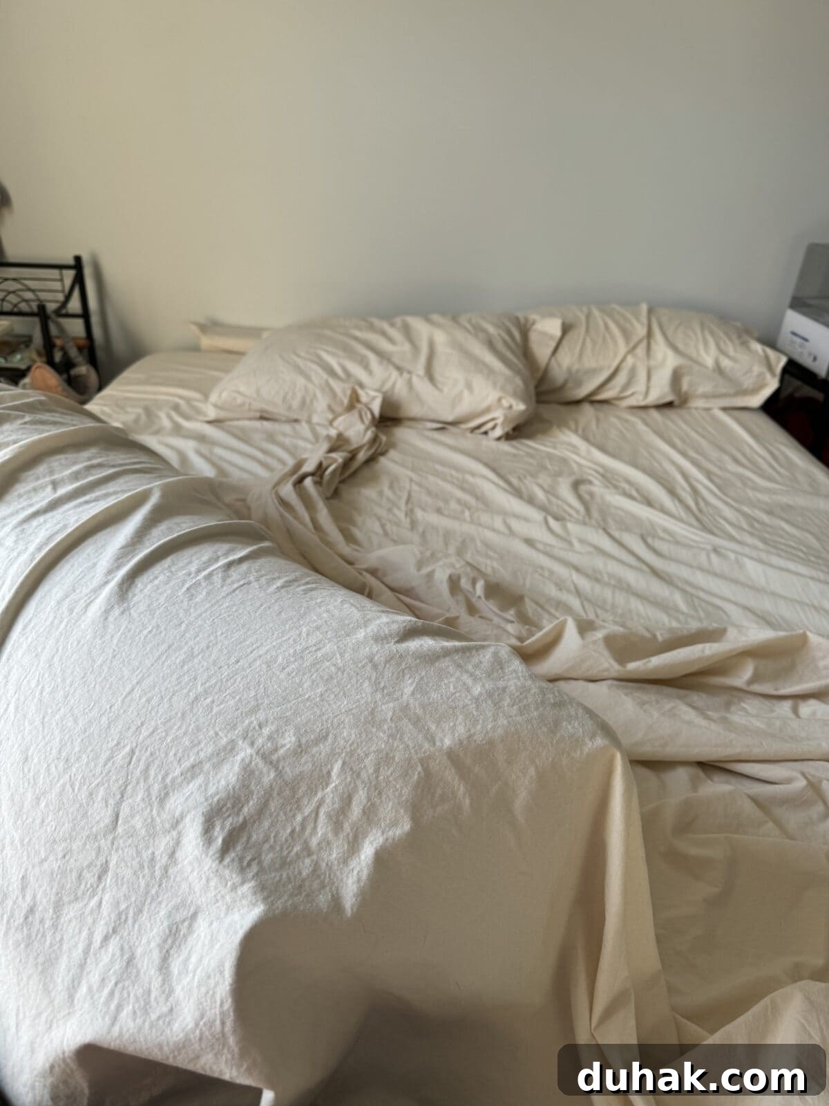 American Blossom Linens Review: 100% USA-Made Bedding Guide 6 Vertical - morning light shining on messy ABL sheets on queen bed