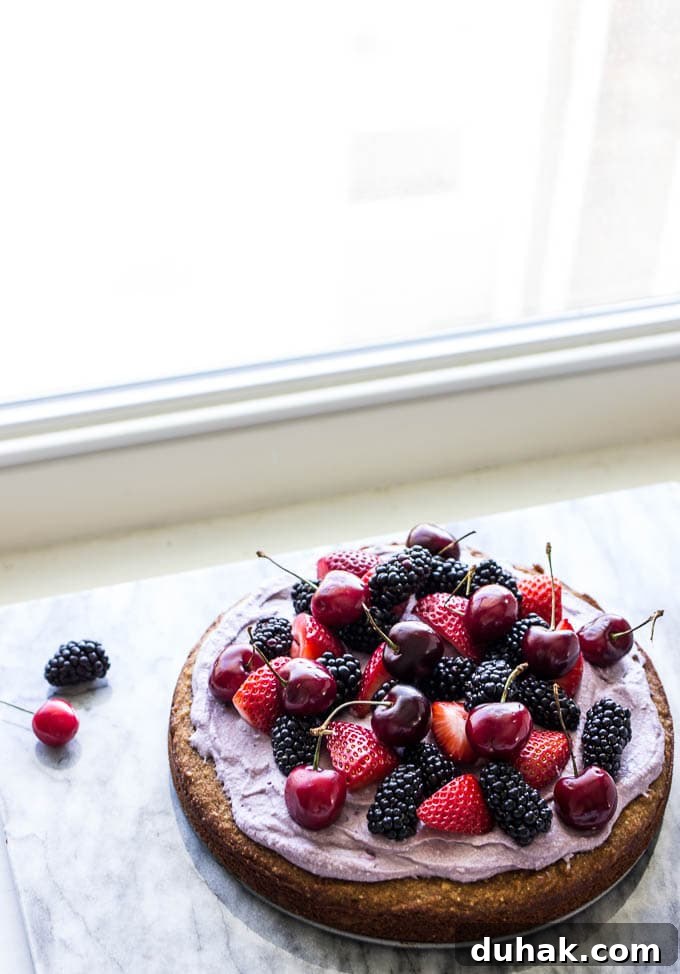 Coconut Cake with Blackberry-Coconut Whipped Cream and Mixed Berries