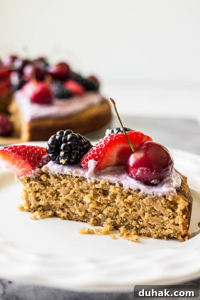 slice of cake with strawberries, blackberries, and cherries