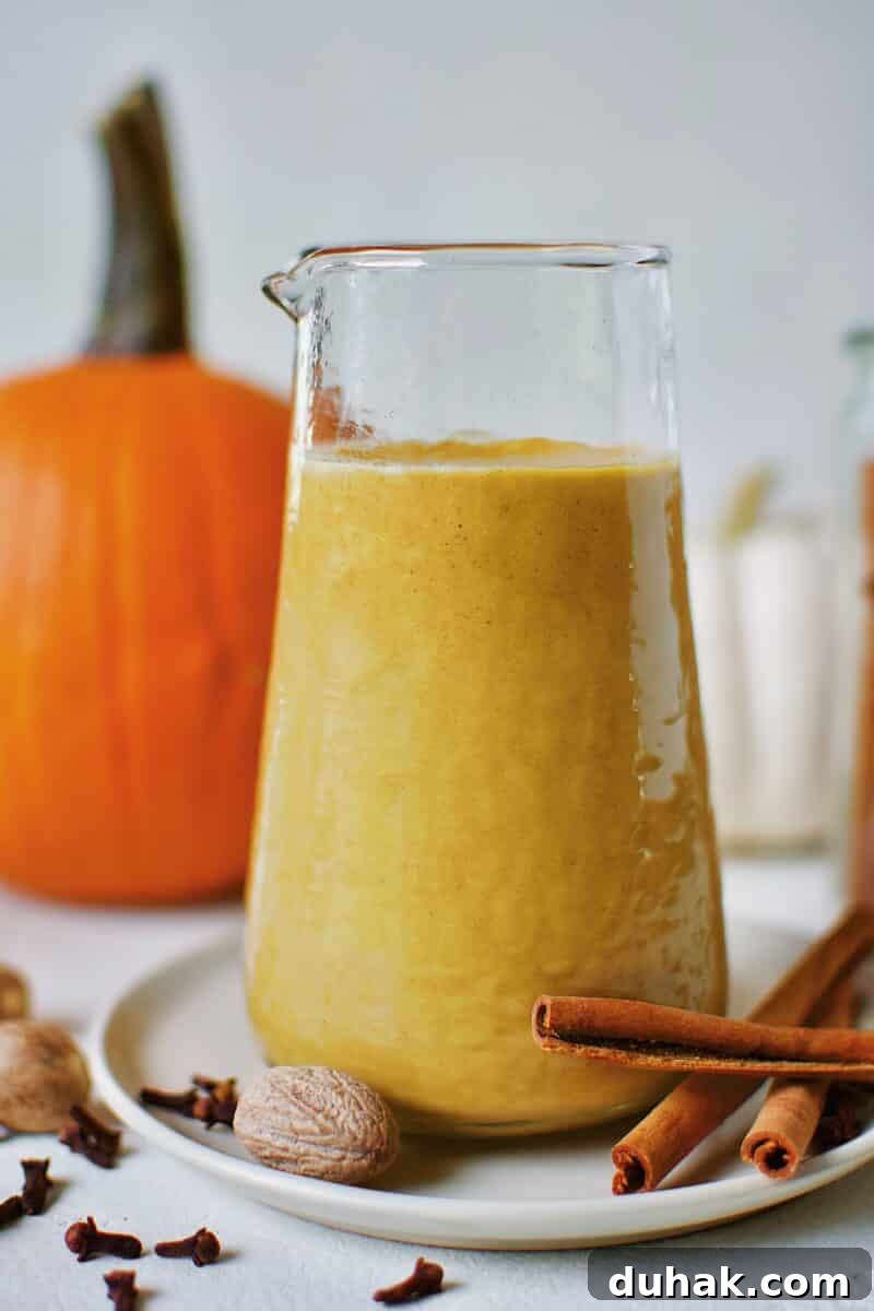 Sugar-Free Pumpkin Spice Syrup in a carafe ready for morning coffee to make a homemade Pumpkin Spice Latte.
