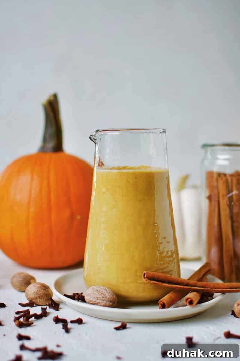 Sugar-Free Pumpkin Spice Syrup in a carafe ready for morning coffee to make a homemade Pumpkin Spice Latte.