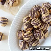 Crazy easy peanut butter pretzel honey balls! Sweet, salty and made with just six simple ingredients! Including a dark chocolate drizzle!