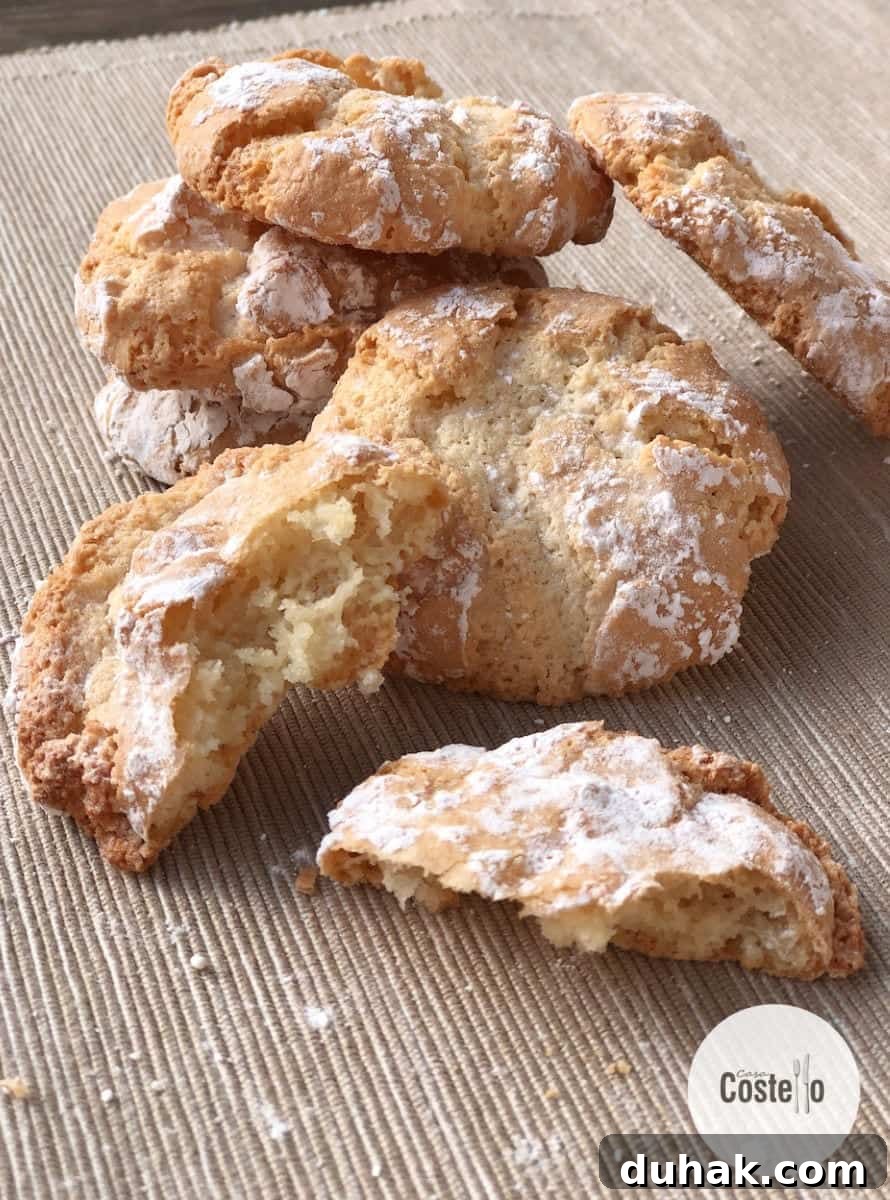a stack of crunchy amaretti cookies with one broken in half
