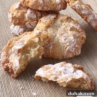 Stack of Amaretti cookies surrounded by crumbs