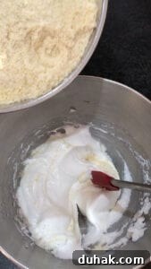 Stirring in ground almonds to whisked egg whites