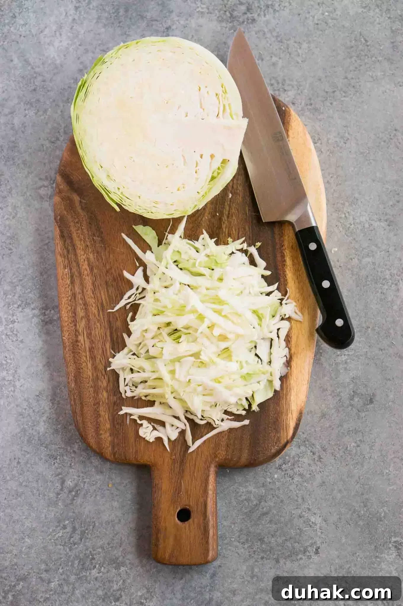 How to Cut Cabbage Like a Pro: Step-by-Step Guide 2 shredded cabbage on a cutting board and a knife