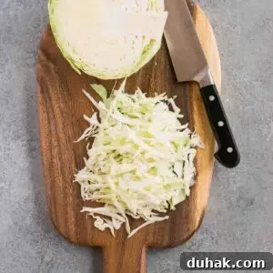 How to Cut Cabbage Like a Pro: Step-by-Step Guide 7 shredded cabbage on a cutting board and a knife