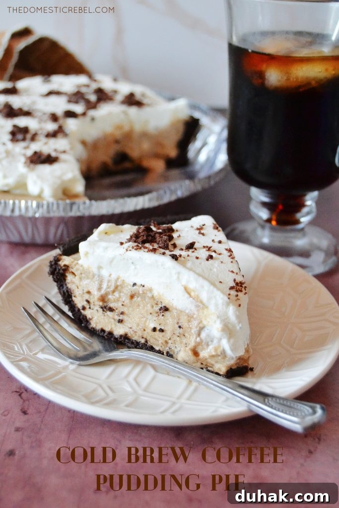 a slice of cold brew coffee pie on a white plate with a silver fork and the whole pie in the background