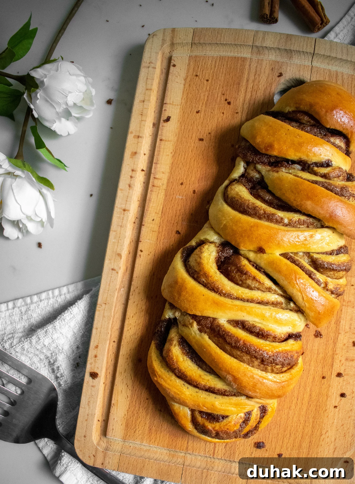 Cinnamon roll loaf on a cutting board.